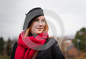 Young woman with red scarf and black beret