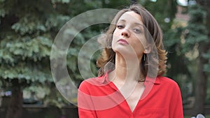 Young woman in red shirt wearing surgical mask on the face for protection from virus during pandemia. Coronavirus Covid