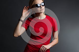 A young woman in a red slinky dress, sunglasses