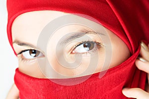 Young woman in red veil