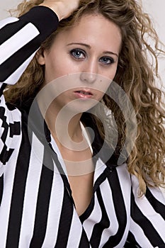 Young woman in referee striped shirt