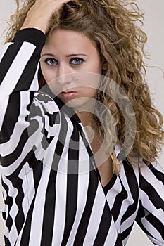 Young woman in referee striped shirt