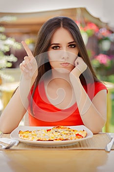 Young Woman Refusing To Eat a Pizza