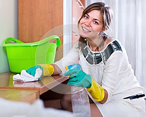 Young woman regular polishing shelves