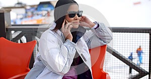 Young woman relaxing at an alpine ski resort