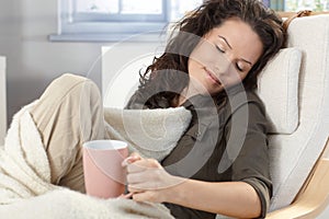 Young woman relaxing in armchair