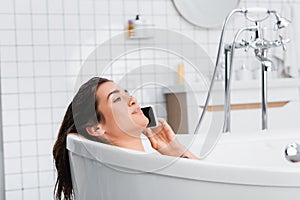 young woman relaxing in bathtub on