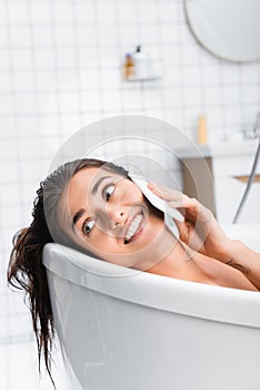 young woman relaxing in bathtub on