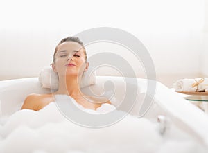 Young woman relaxing in bathtub