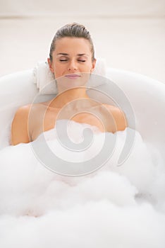 Young woman relaxing in bathtub