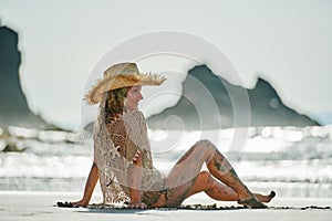 Young woman relaxing on the beach in summer day