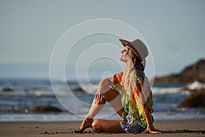 Young woman relaxing on the beach in summer day