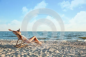 Young woman relaxing in deck chair