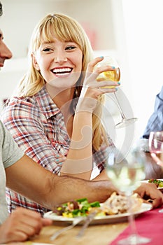 Young Woman Relaxing At Dinner Party