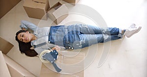 Young woman relaxing on the floor after packing