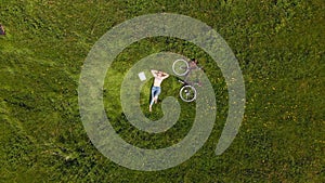 Young woman relaxing in green field 4k