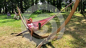 Young woman relaxing in the hammock