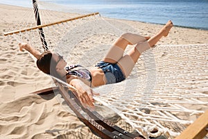 Young woman relaxing in hammock