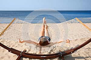 Young woman relaxing in hammock