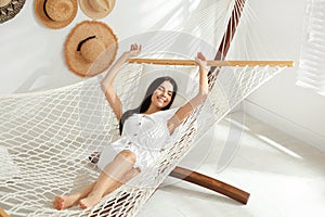 Young woman relaxing in hammock