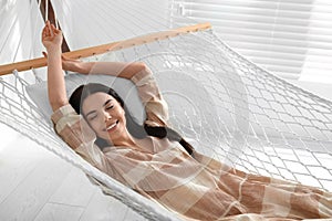 Young woman relaxing in hammock