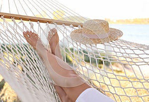 Young woman relaxing in hammock on beach, closeup. Summer vacation
