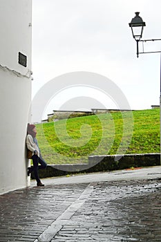 Young woman relaxing on Hondarribia old village streets during a winter morning walk, Basque Country, Spain