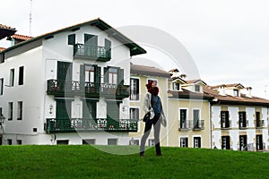 Young woman relaxing on Hondarribia old village streets during a winter morning walk, Basque Country, Spain