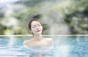 Young woman relaxing in hot springs