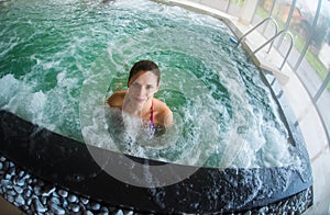 Young woman relaxing in an indoor pool