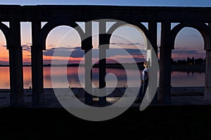 Young woman relaxing on the lake at sunset