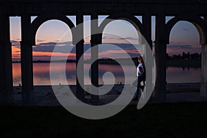 Young woman relaxing on the lake at sunset