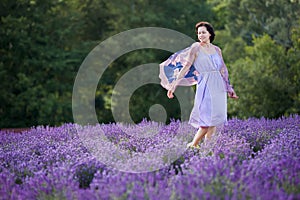Young woman relaxing in lavender field