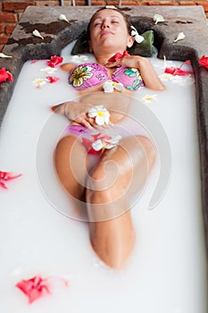 Young woman relaxing on the milk bath