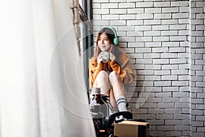Young Woman Relaxing with Music From Headphone in Cozy House, En