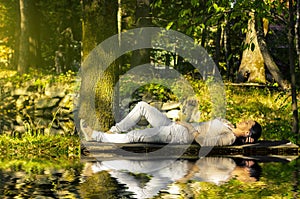 Young woman relaxing near water on pontoon