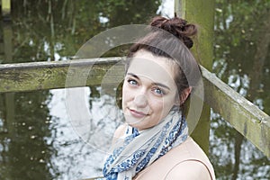 Young woman relaxing by pond 001