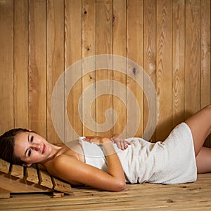 Young woman relaxing in a sauna