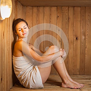 Young woman relaxing in a sauna