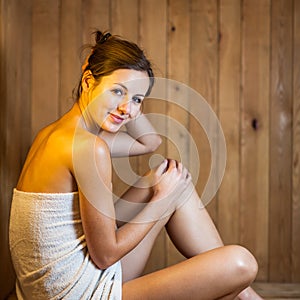 Young woman relaxing in a sauna