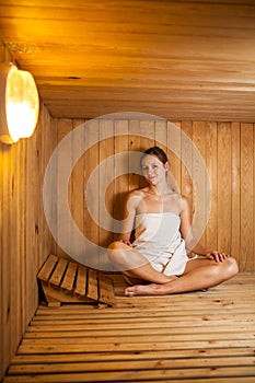 Young woman relaxing in a sauna