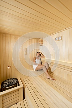 Young woman relaxing in the sauna