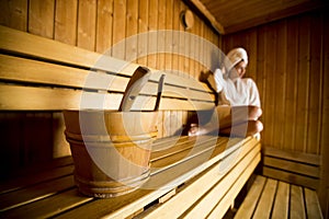 Young woman relaxing in the sauna at spa center