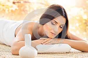 Young woman relaxing on a spa massage procedure