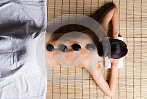 Young woman relaxing on a spa massage procedure