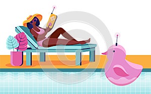 A young woman is relaxing on a sun lounger next to the pool and playing with a radio-controlled toy. Toy for swimming pool with