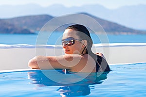 Young woman relaxing at swimming pool