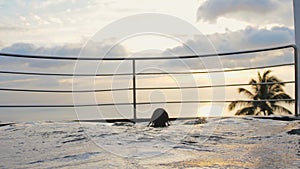 Young woman relaxing in swimming pool at luxury hotel spa enjoying beautiful sunset view of ocean