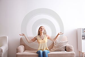 Young woman relaxing under air conditioner