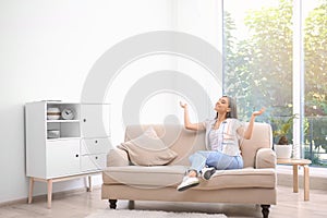 Young woman relaxing under air conditioner